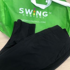 Swing control black golf pants with bag.